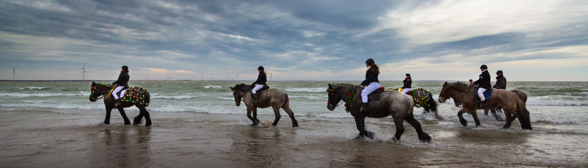 Reiter vor beeindruckendem Wolkenhimmel über der Nordsee