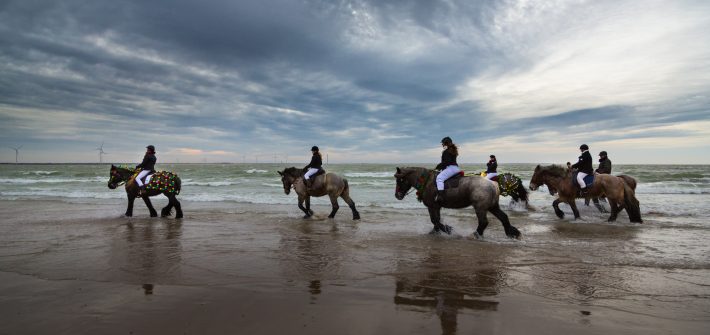 Reiter vor beeindruckendem Wolkenhimmel über der Nordsee